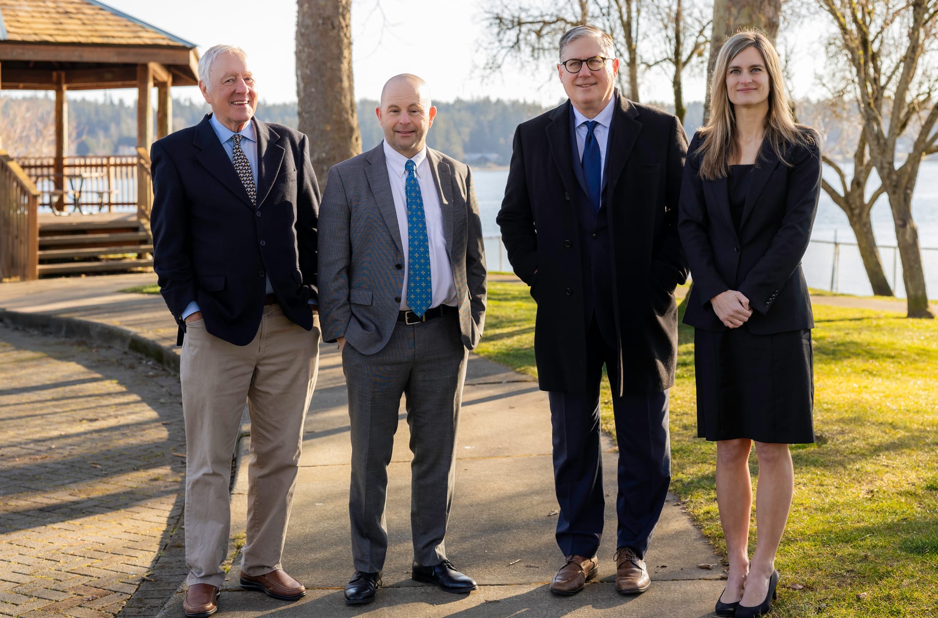 Kitsap Law Group attorneys Bill H. Broughton, David P. Horton, David A. Weibel and Christy Palmer on a waterfront path beside Puget Sound