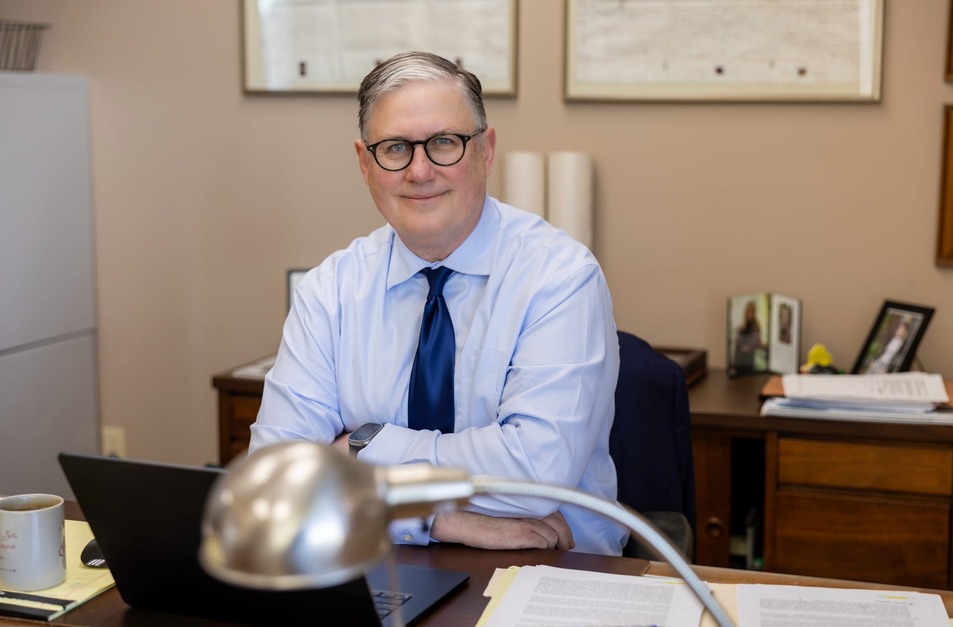 Attorney David A. Weibel reviewing papers at his desk