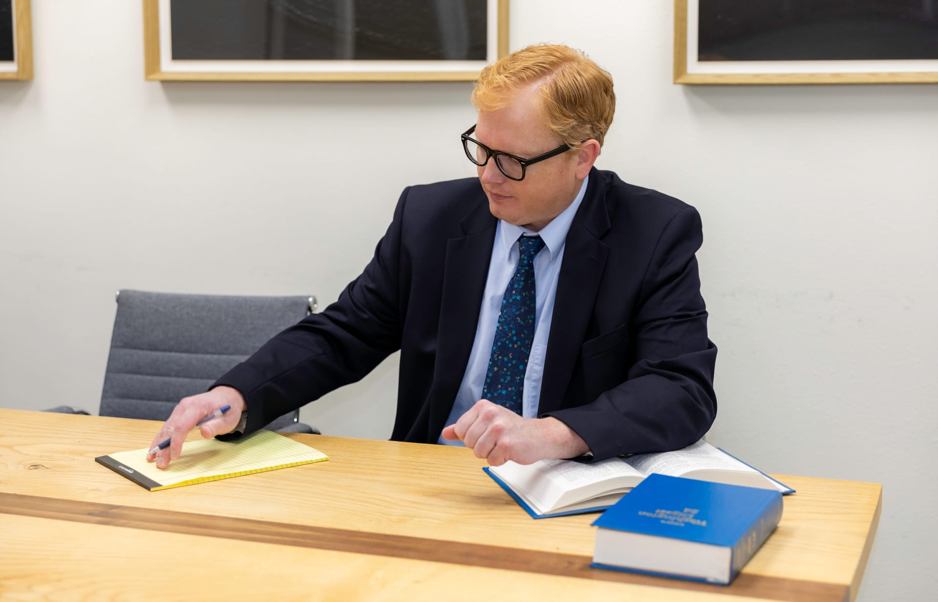 Attorney John Brennan reviewing a law book in the Kitsap Law Group conference room