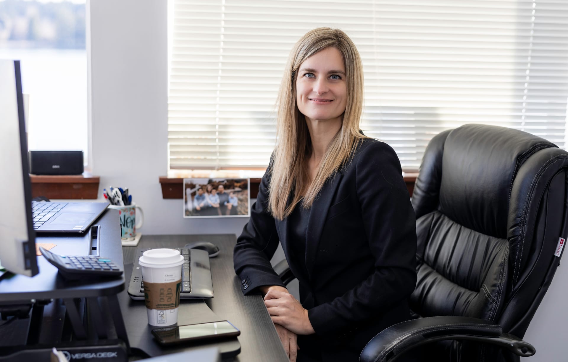Attorney Christy Palmer at her desk, with the water visible through her office window