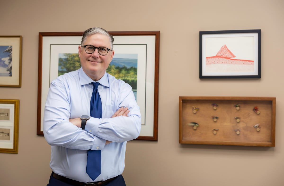 Partner David A. Weibel standing in his office with his arms crossed