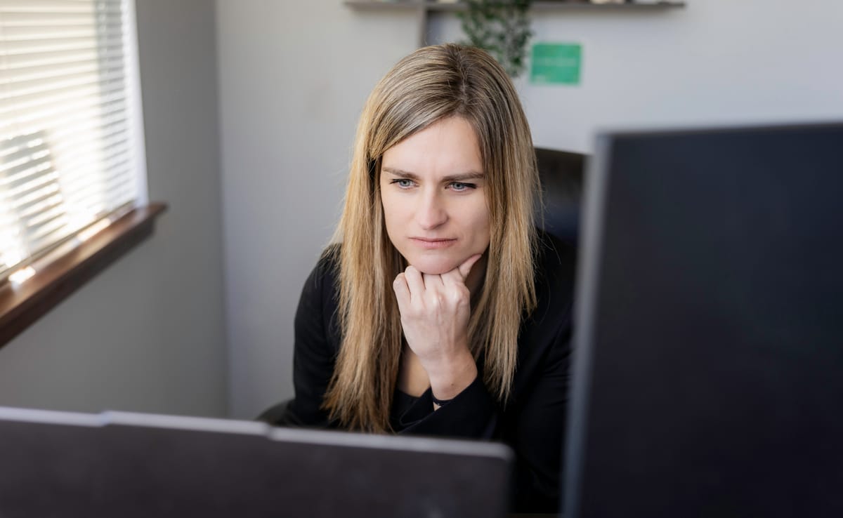 Christy Palmer at her desk behind a monitor