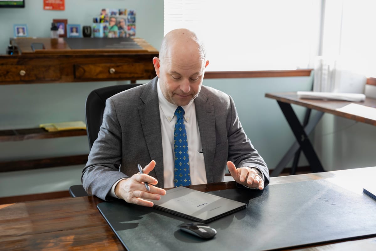 David P. Horton working at his desk with a tablet