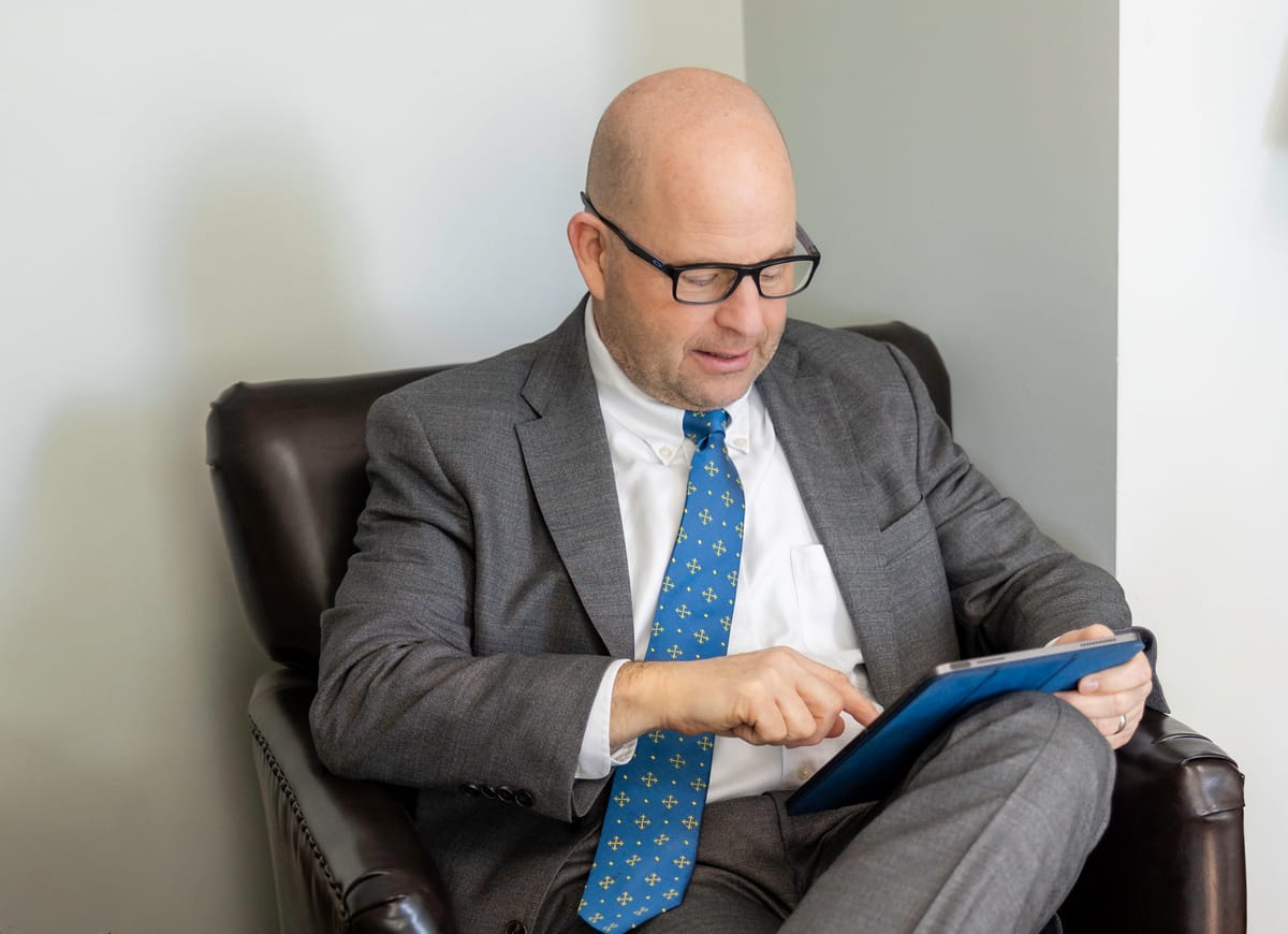 David P. Horton, Managing Partner at Kitsap Law Group, seated in a leather chair
